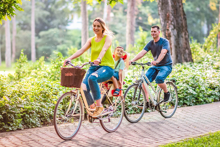 Employee Benefits - Happy Family Is Riding Bikes Outdoors